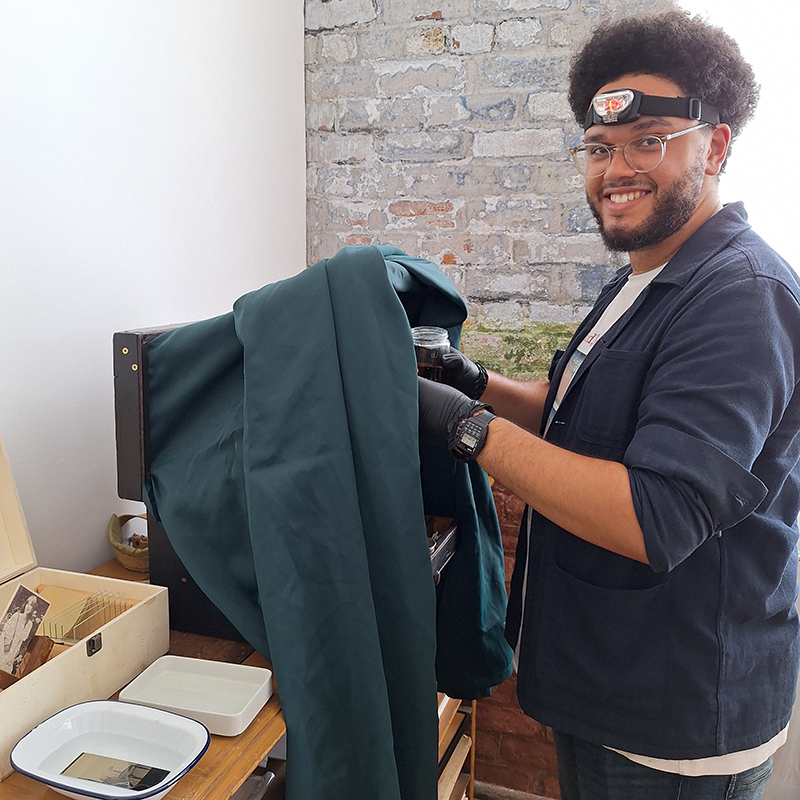 Adam smiling at his portable darkroom