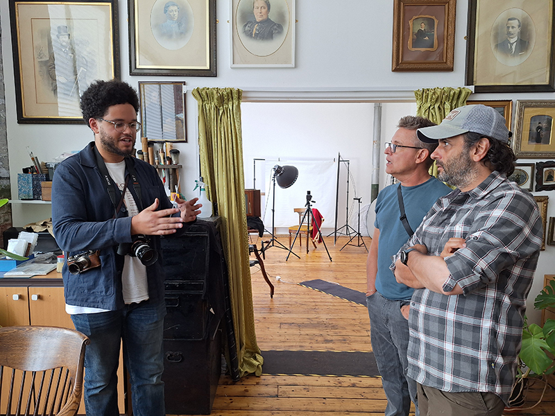 Adam explaining something to Shane and Simon