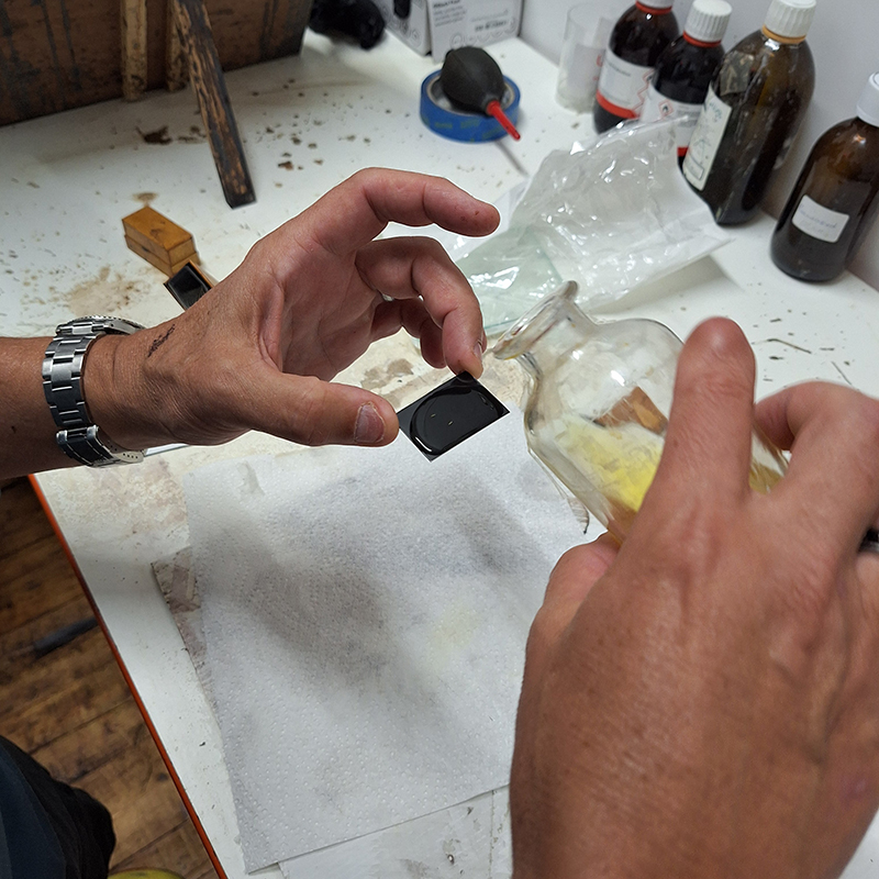 Shane pouring a tiny tintype.